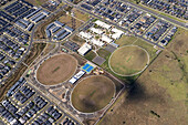 Aerial view of mcnab recreation reserve with sports fields and residential area,cranbourne west,australia