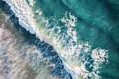 Large ocean waves rolling in motion with crystal clear blue water and white foam,captured from above,Port Noarlunga,South Australia,Australia
