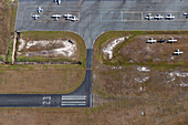 Aerial view of airport with small aircraft on runway and tarmac surrounded by grass,Caloundra West,Australia