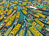 Bangladesh - 15 February 2023: Aerial view of floating market of seasonal fruits on the boats in Kaptai Lake,Rangamati,Bangladesh