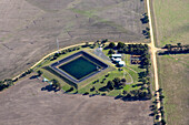 Aerial view of water treatment plant surrounded by farmland and greenery,Meredith,Australia