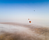 Aerial view of a group of hot-air-balloon flying in the clouds of the Murqquab desert in Dubai,U.A.E
