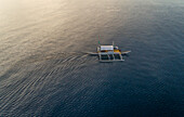 Aerial view of single filipino fishing boat near Lapu-Lapu city,Philippines