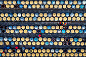 Aerial view of colourful clay urns for fish sauce fermentation with a worker in a yellow hat,Ham Tien,Phan Thiet,Vietnam