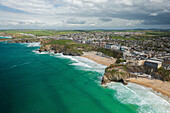 Aerial view of Great Western Beach Newquay watching surfing on the rugged north coast,with Newquay town in the background,Cornwall,United Kingdom
