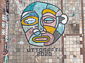 Amsterdam,Netherlands - 28 April 2021: Aerial view of a big graffiti showing a face painted on the ground in Amsterdam,Netherlands