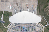 Aerial view of Aeropuerto de Carrasco with airplanes on the runway and surrounding urban landscape,Canelones,Uruguay