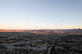 Aerial view of colorful hot air balloons over a breathtaking landscape at sunrise,Goreme,Turkey