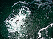 Aerial view of dramatic stormy sea and rocky cliffs close to the Knysna Heads in Knysna,Western Cape,South Africa
