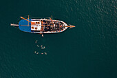 Aerial view of people jumping off the boat into the Mediterranean Sea in La Valletta,Malta
