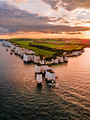 Aerial view of beautiful coastal cliffs and serene ocean at sunset,England,United Kingdom