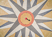 Abstract aerial view of person holding an umbrella in the middle of a compass rose,USA