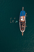 Aerial view of people jumping off the boat into the Mediterranean Sea in La Valletta,Malta