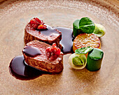 Venison and nuts with spinach rolls and barberries