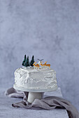 Christmas cake with frosting and forest decorations