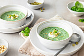 Basil soup with crème fraîche, pine nuts and pesto croutons