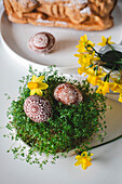 Artfully designed Easter eggs on green cress
