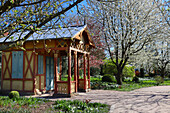 Historic pavilion in the blossoming orchard in spring