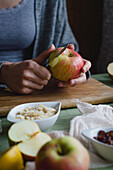Woman peeling apple with knife