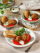 Kofte with bell pepper sauce and yogurt