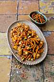 Potato salad with tamarind sauce, pistachios and Bombay mix