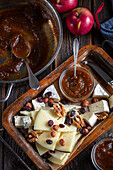 Cheese platter with nuts and apple and coffee jam