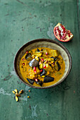 Korma curry with aubergines, pistachios and pomegranate