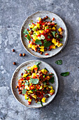 Vegan mango and tomato salad with brown chickpeas and mint