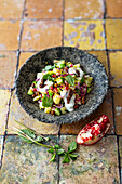 Indian jacket potato salad with cucumber, chickpeas and pomegranate