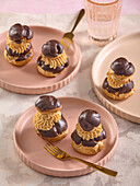 Chocolate cream puffs with caramel cream