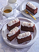 Chocolate liqueur cake slices with cream