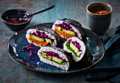 Japanese onigiri with avocado. Red cabbage, spinach and sweet potato