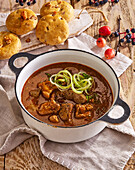 Hearty pork goulash with bacon cakes