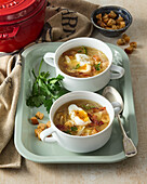 Rich garlic soup with bacon and egg