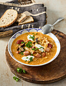Sauerkraut soup with mushrooms and meat garnish