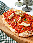 Pinsa with caper apples and artichoke hearts
