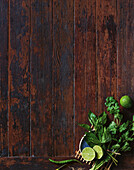 Wooden base with coriander, Thai basil, lime and green chilli