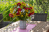 Bouquet of goldenrod, dahlias, sneezewort (Achillea ptarmica) and grasses