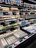 Different egg cartons on the supermarket shelf