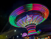 Colorful motion blur of spinning ride at a carnival.