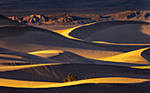 Dramatic sunset light on the Mesquite Sand Dunes in Death Valley National Park, California, USA.