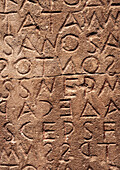 Letters of ancient Greek alphabet carved into an old stone, Heraklion Archaeological Museum, Crete island, Greece