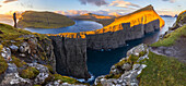 A trekker at Sørvagsvatn during sunset, Vagar, Faroe Islands, Denmark, Scandinavia