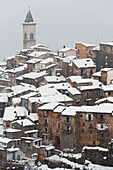 The medieval village of Pacentro under heavy snowfall with snow covered house and tower bell, Pacentro municipality, Maiella national park, L’aquila province, Abruzzo, Italy
