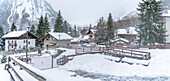 View of snow covered wooden houses and church in Entreves in winter, Entreves, Aosta Valley, Italian Alps, Italy