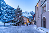 View of Christmas tree and decorations in Piazza Abbe Henry at dusk, Courmayeur, Aosta Valley, Italian Alps, Italy