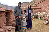 Family in yard of house tied to their work, village of Tighza, Ounila River valley, Ouarzazate Province, Draa-Tafilalet region, Morocco