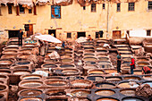 Rows of dye-filled stone basins in a traditional leather tannery in Fes, Morocco