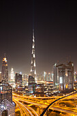 Dubai skyline at dusk with Burj Khalifa, the world tallest building and Sheikh Zayed road traffic, Dubai, United Arab Emirates