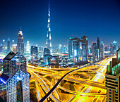 Dubai skyline at dusk with Burj Khalifa, the world tallest building and Sheikh Zayed road traffic, Dubai, United Arab Emirates
